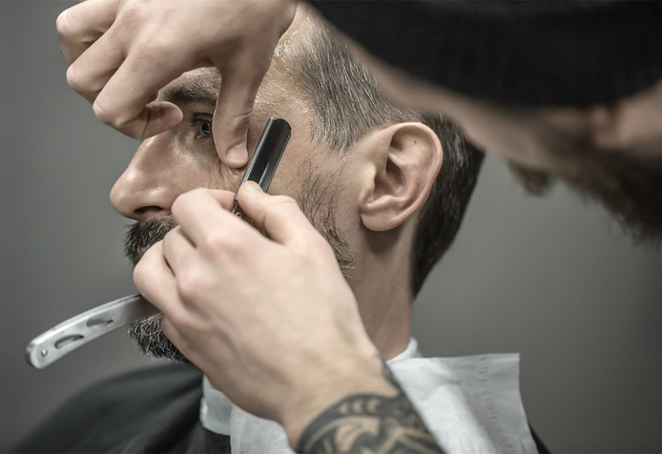 Barber Shaving the Face of a Man
